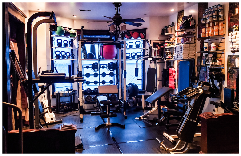 The fitness room inside Perry Mansion, equipped with weights and cardio machines, supporting the Move Safely pillar.