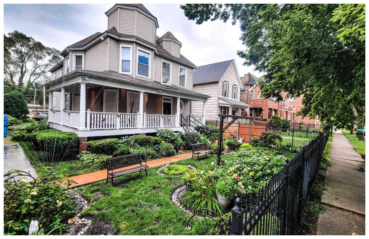 The Perry Mansion, a century-old Queen Anne Victorian house with a wraparound porch and garden in Englewood, Chicago.